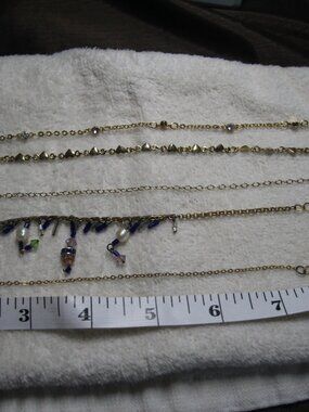 Anklets 5 for 1 price gold tone. Worn conidtion.